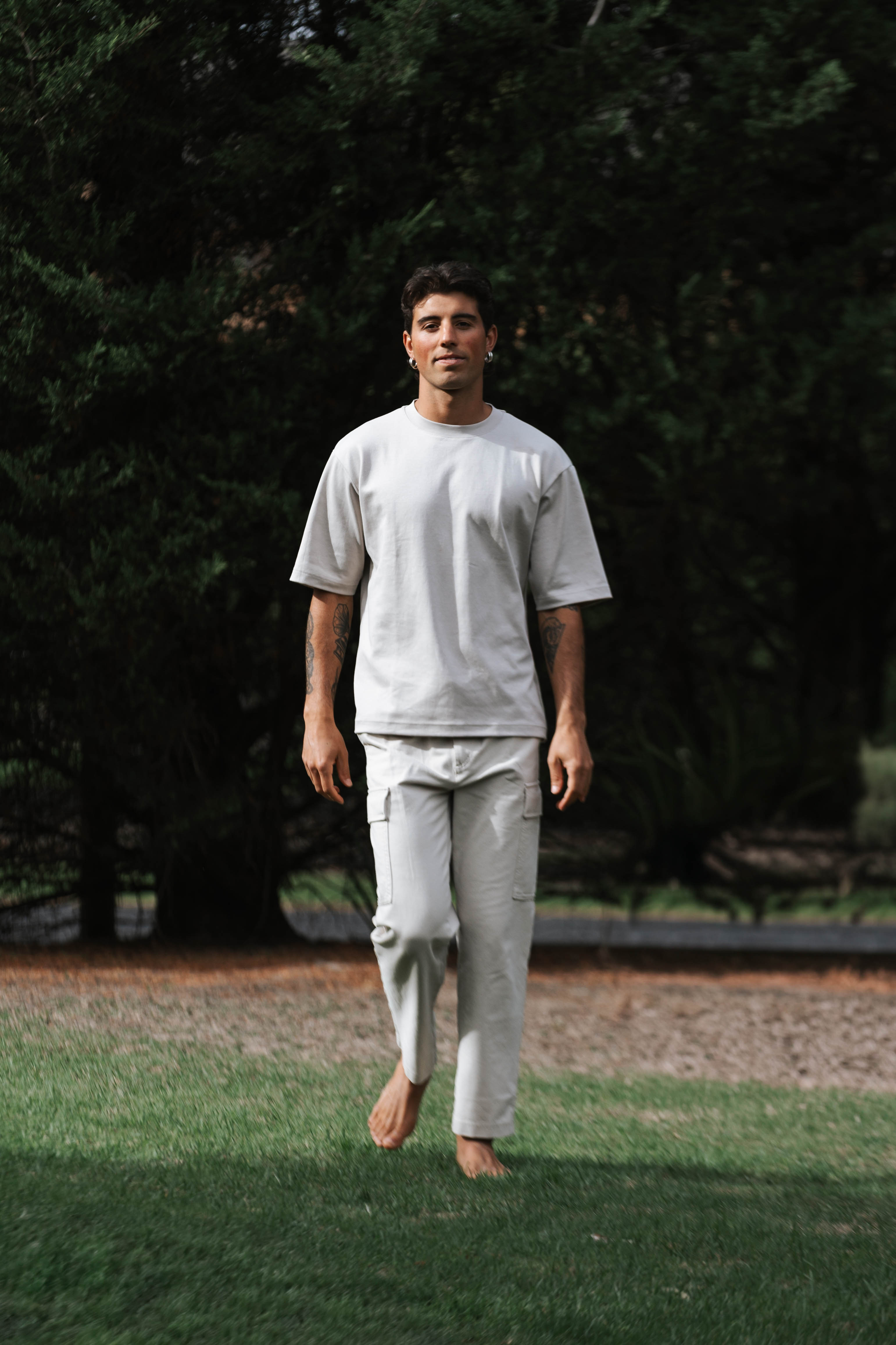 Tristan walking forward barefoot on grass — from lost to living